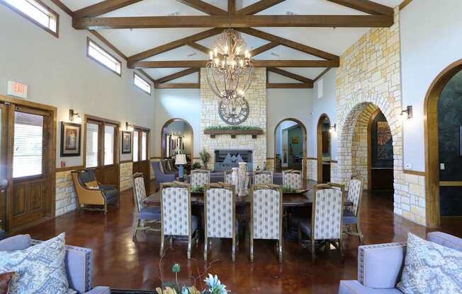 A large room with a fireplace and a chandelier.