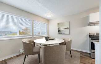 Dining area at Peak 88 Apartments in Renton, WA with table seating and open layout