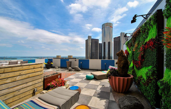 a rooftop patio with a view of the city and the ocean