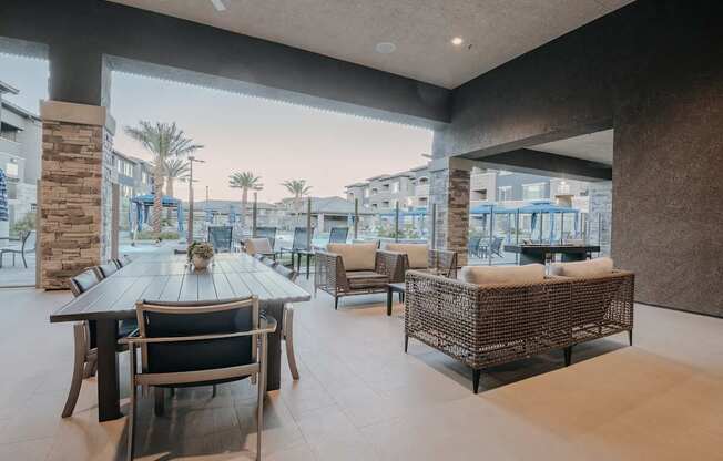 Oversize outdoor patio with table and chairs and other comfortable seating overlooking the resort style pool