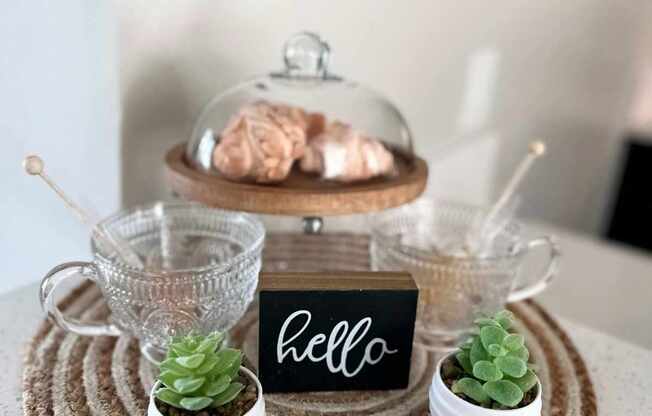 a table with a plate with a sign and plants on it