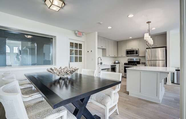 A modern kitchen with a dining table and chairs.