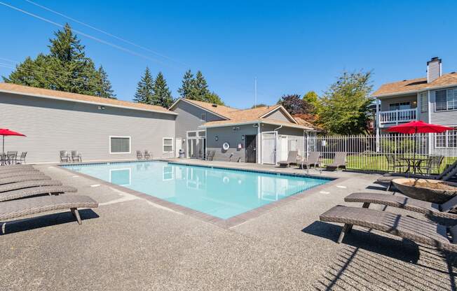 our apartments have a swimming pool with chairs and tables