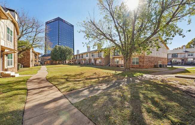 A sunny day in a residential area with a pathway and houses.