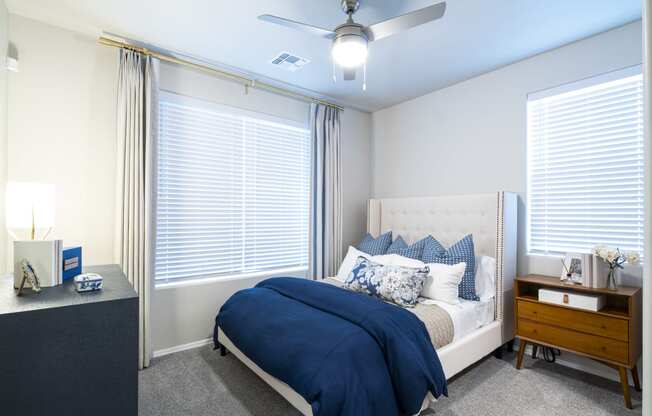 a bedroom with a bed and a ceiling fan