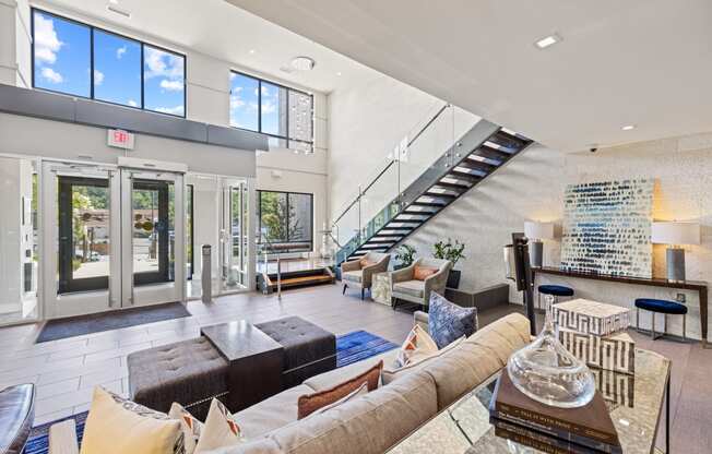 a living room filled with furniture and a staircase