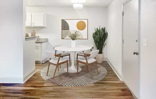 an open kitchen and dining room with a white table and chairs