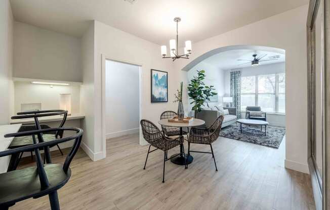 a dining room and living room with a table and chairs