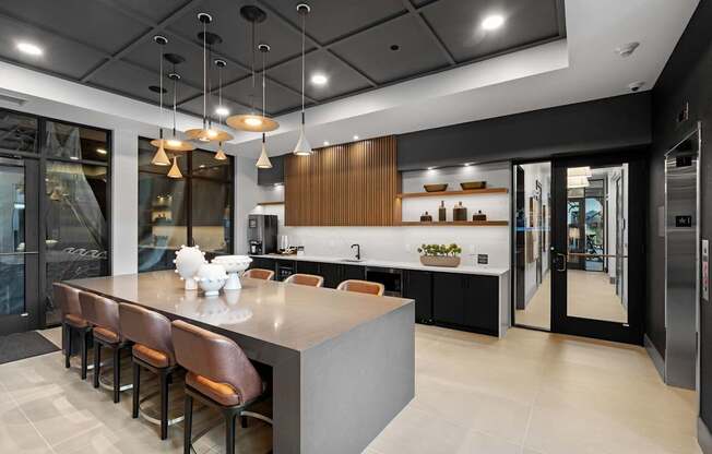 A modern kitchen with a long island and bar stools.