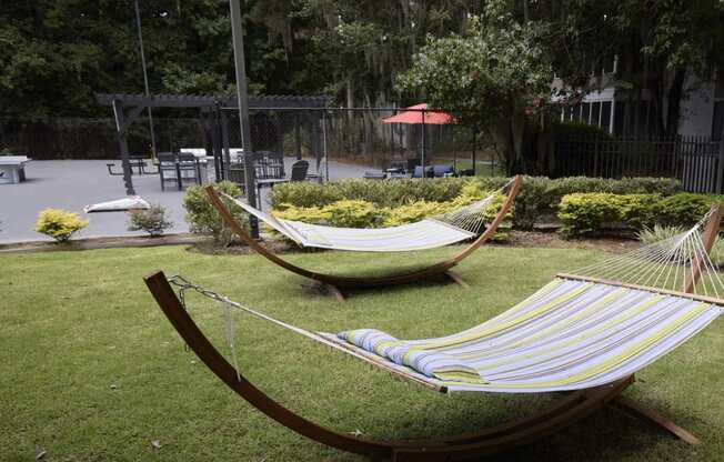 Greentree Apartments in Savannah, GA photo of two hammocks on the lawn in a garden