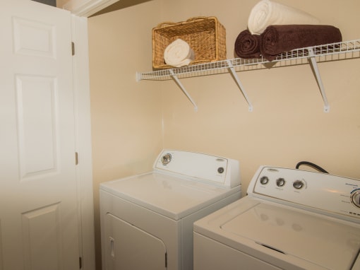 a small laundry room with a washer and dryer and a shelf above the at Echo at Lake Norman, Mooresville, NC 28117