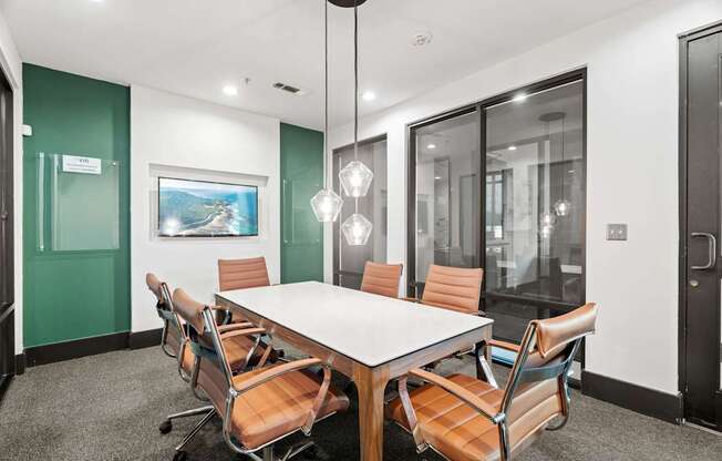 A conference room with a long table and chairs.