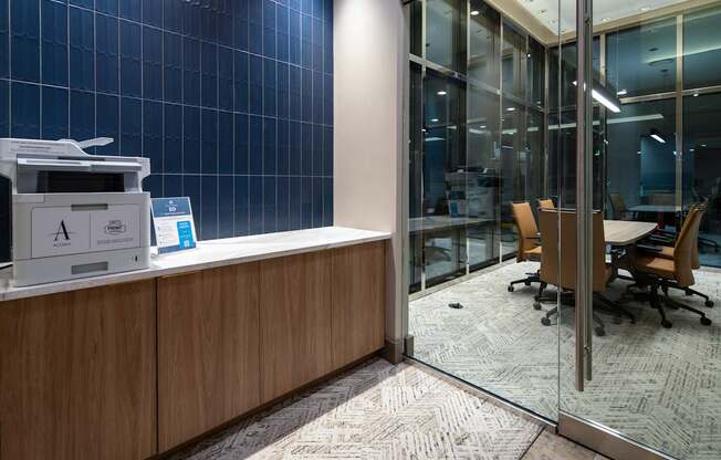 A reception desk with a printer and a blue screen on top.