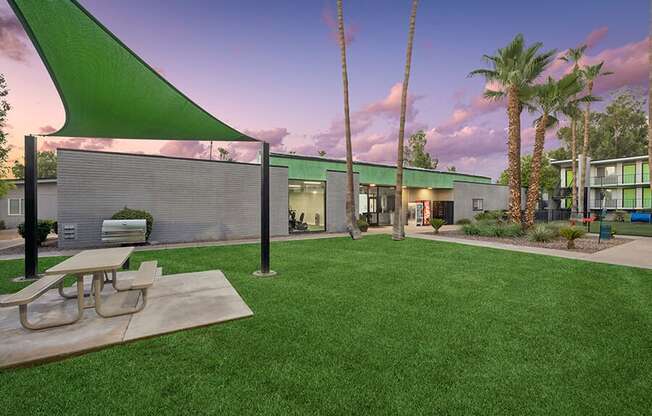 Outdoor BBQ Area with Canopy and Picnic Table at Arcadia on 49th Apartments located in Phoenix, AZ.