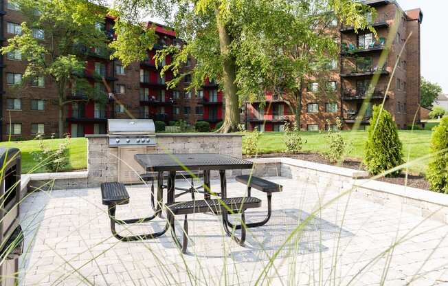 patio with a picnic table and grilling station