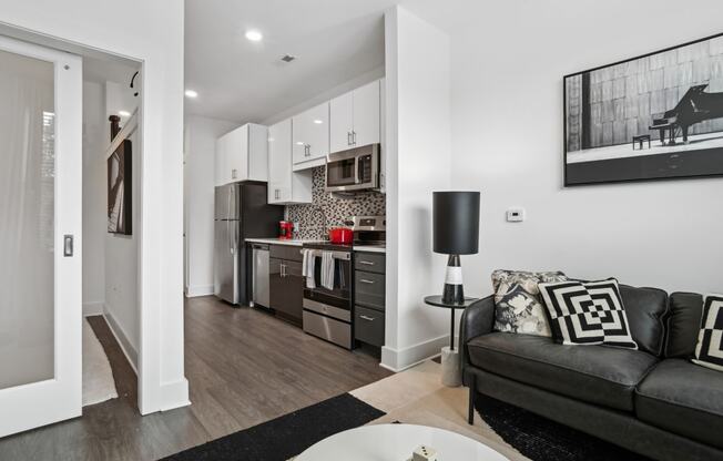 a living room with a couch and a table at Link Apartments® Mint Street, North Carolina