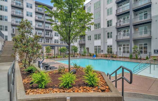 a swimming pool in front of an apartment building