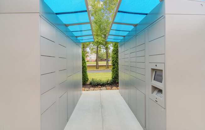 a hallway with white cabinets and a blue roof and a green field in the background at Highlands Apartment Homes, Bartlett, 38135