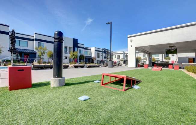 Grassy patch for cornhole near the pool and outside lounge area