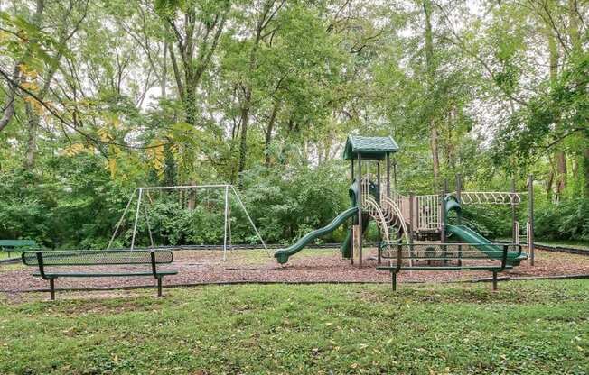 a playground with a swing set and a jungle gym at Station JTown, Louisville, 40299