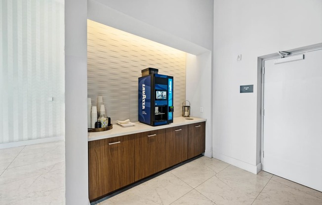 a coffee machine on a counter in a room with a door