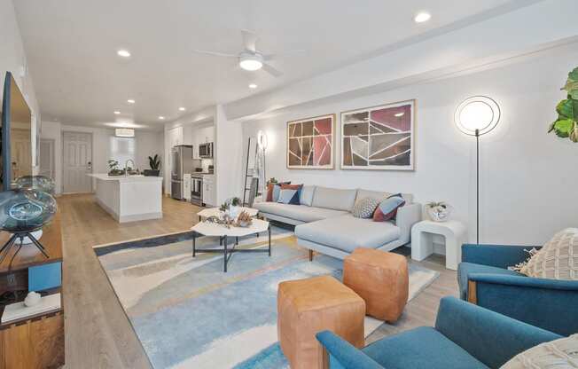 a living room with couches and chairs and a rug