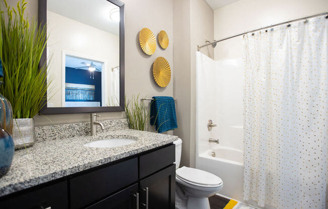 a bathroom with a sink and a shower and a toilet