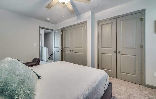 a bedroom with a large bed and a ceiling fan