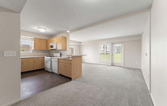 A kitchen with wooden cabinets and a white dishwasher at Fieldstream Apartment Homes in IA 50023