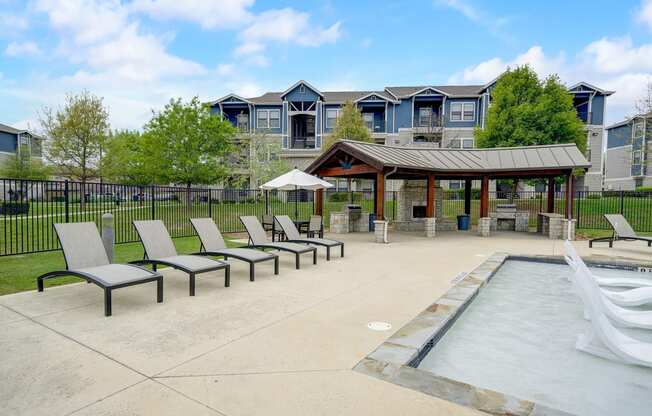 the preserve at ballantyne commons pool and patio with chairs and a pavilion