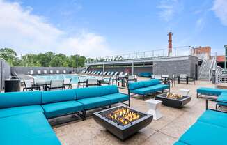 Image of fire pit surrounded by blue sofas