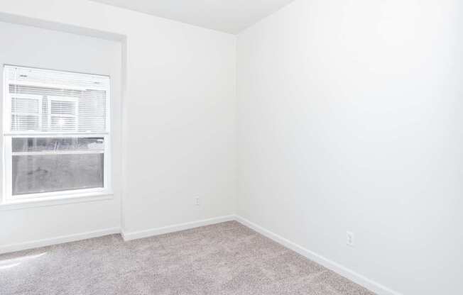 A room with a window and carpeted floor at The Landing Apartments and Townhomes, Oregon, 97045