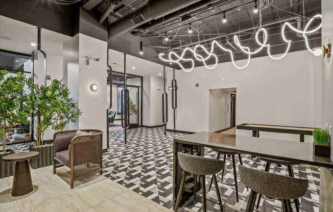 a lobby with a bar and chairs and a table