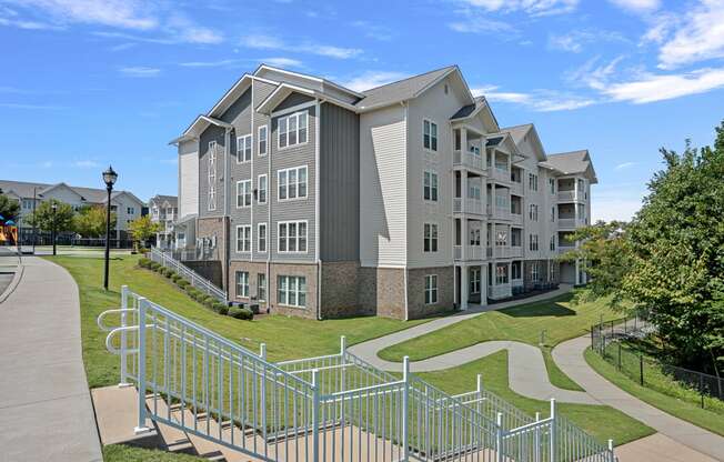 an apartment building with stairs and a sidewalk