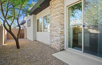 A house with a tree in front of it.