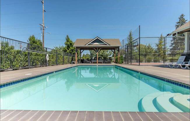 A pool with a gazebo in the middle of it at Forestplace Apartment Homes, Oregon