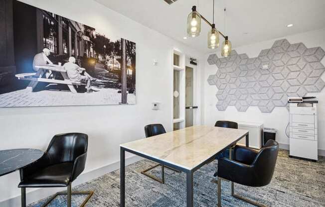 a conference room with a table and chairs and a poster on the wall at Link Apartments® 4th Street, North Carolina, 27101