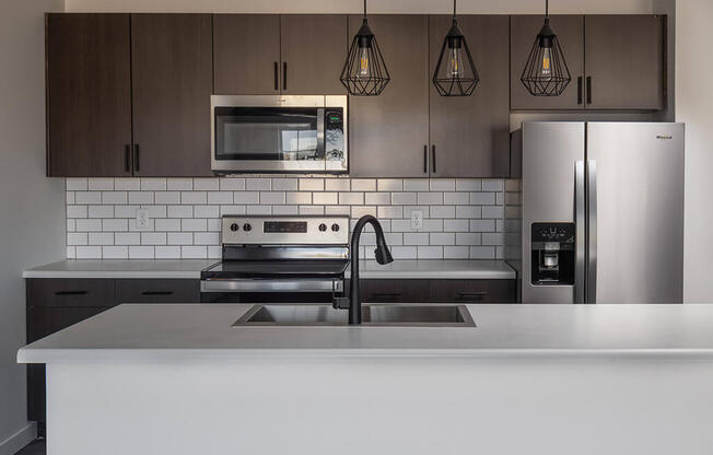 a kitchen with a stove a sink and a refrigerator at 1001 NP, Fargo, North Dakota, 58102
