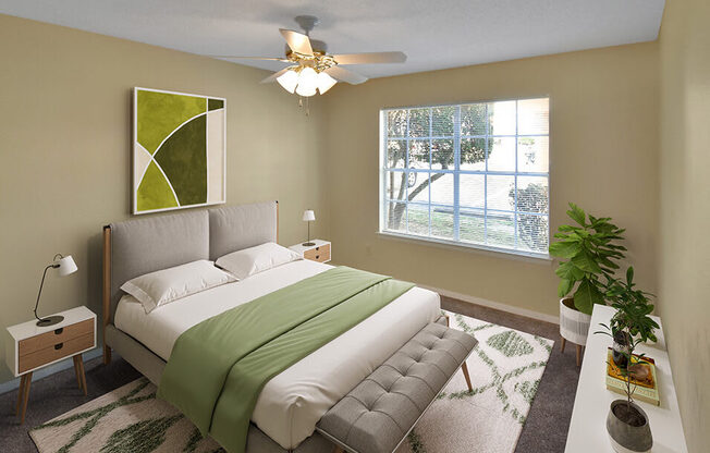 staged apartment bedroom with a ceiling fan