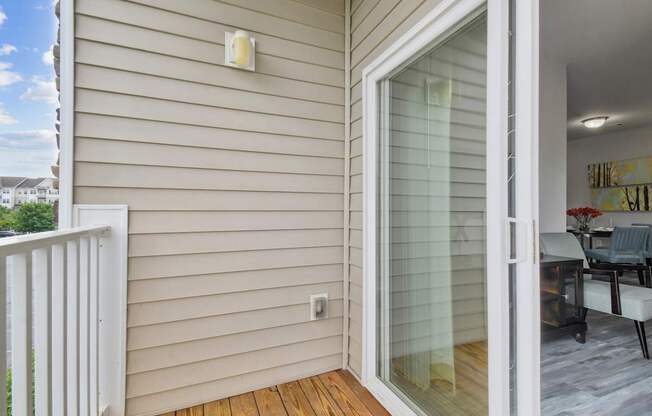 A patio door with a glass panel opens to a living room.
