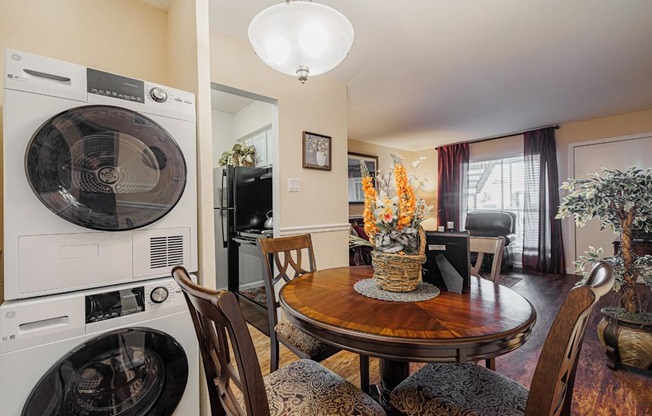 a dining room with a table and chairs and a washer and dryer