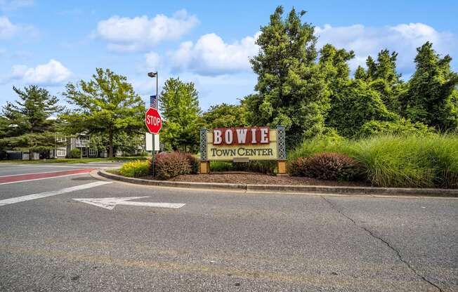 a stop sign in front of a sign for bowie town center at Fairmont at South Lake, Bowie, MD