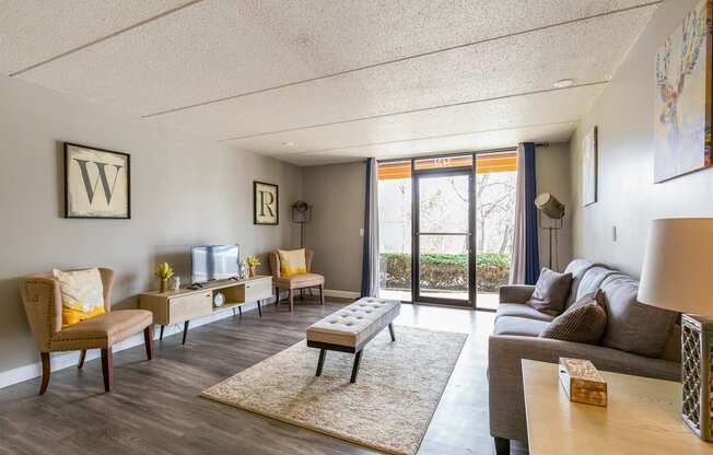 A living room with a grey couch and a white sofa.