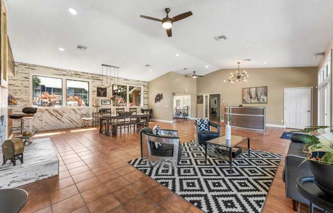 the living room and dining area of a house with a stone wall