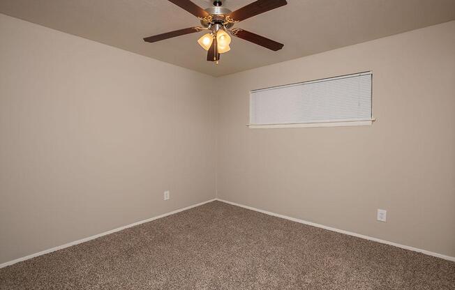 unfurnished carpeted bedroom with a ceiling fan
