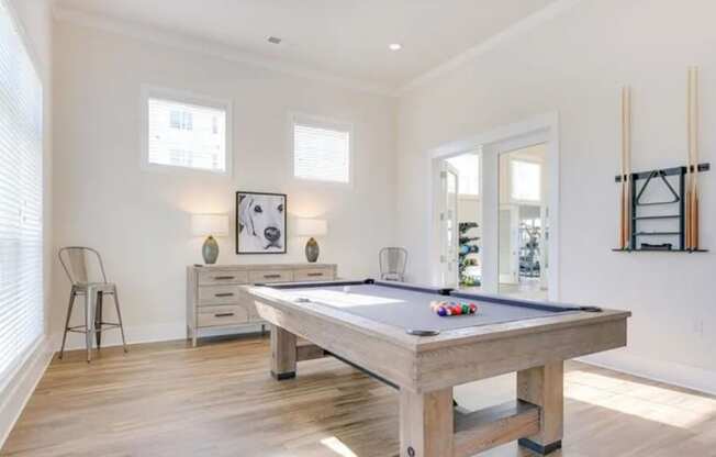a large white room with a pool table in the middle of it