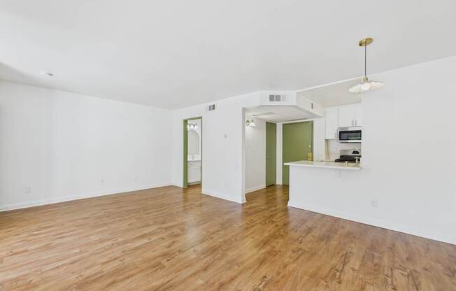 A room with wooden floors and white walls.
