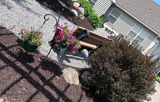 a chair sitting on top of a hill next to a potted plant