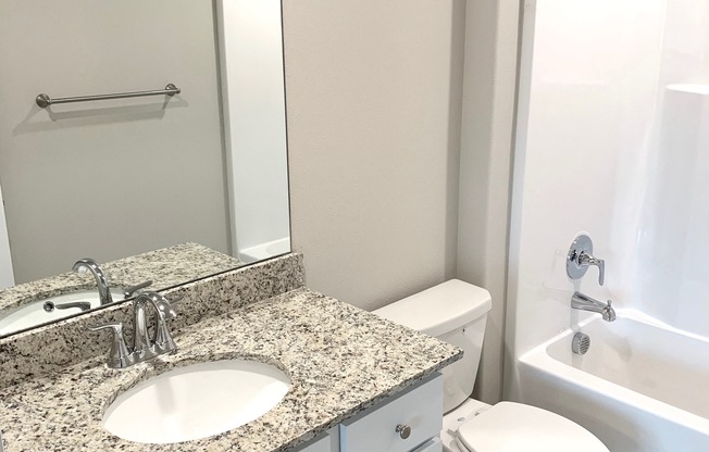 B1 (1-car) Guest Bath with sink, toilet, and shower, granite countertops