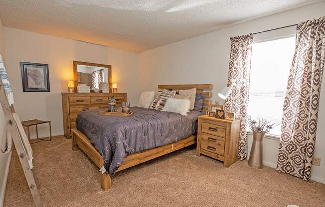 a bedroom with a bed and dresser